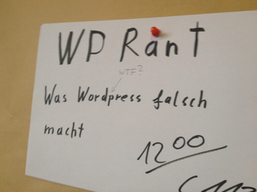 Handschriftliche Notiz auf weißem Papier mit Text 'WP RanT', 'WTF?', 'Was Wordpress falsch macht' und '12.00' mit rotem Punkt als Akzent.