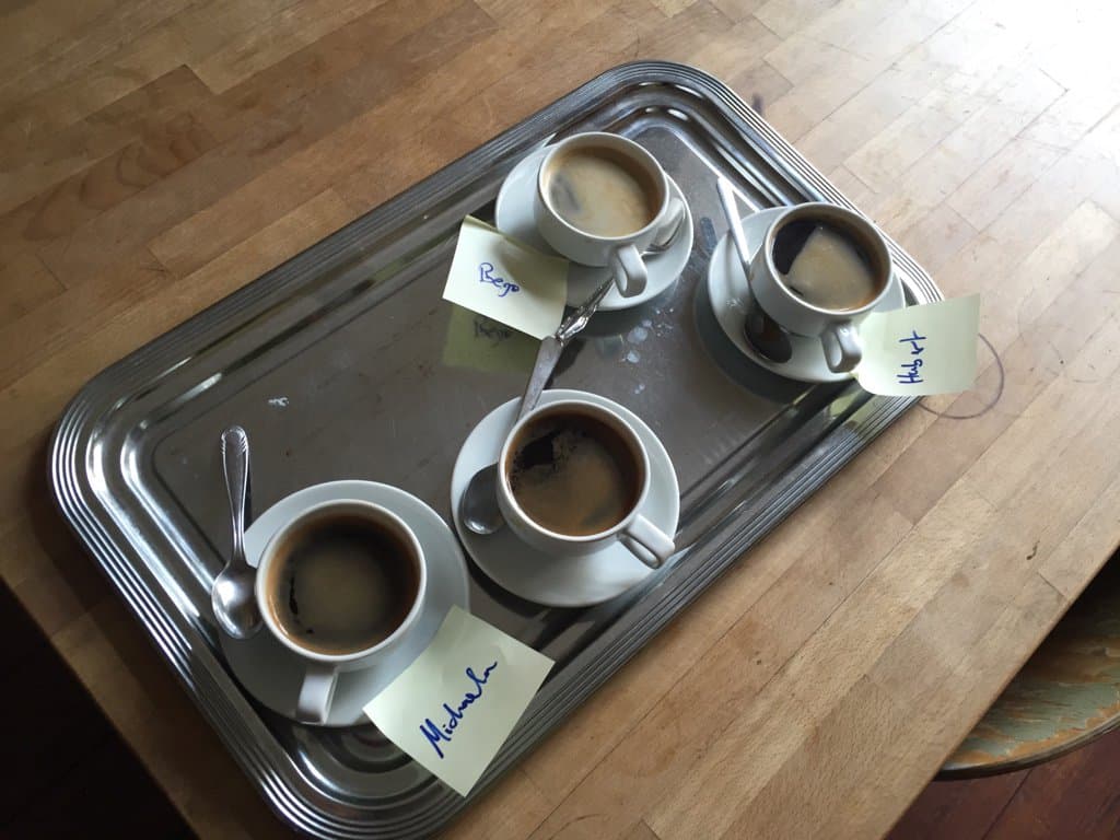 A plate with three coffee cups. Each with a name tag