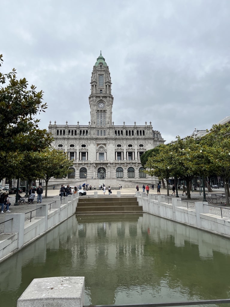 A small pond in the foreground, Porto city hall in the back