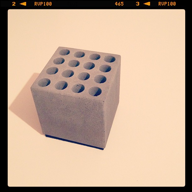 A grey concrete cube with a 4x4