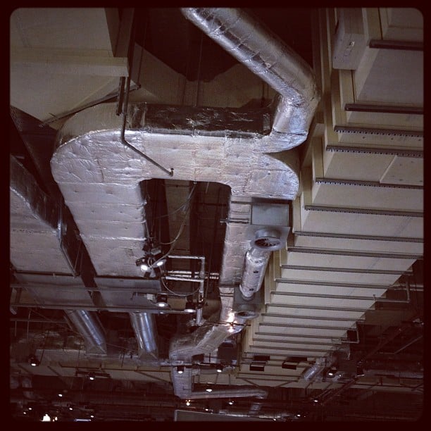 Ceiling with stripped panels and exposed vents