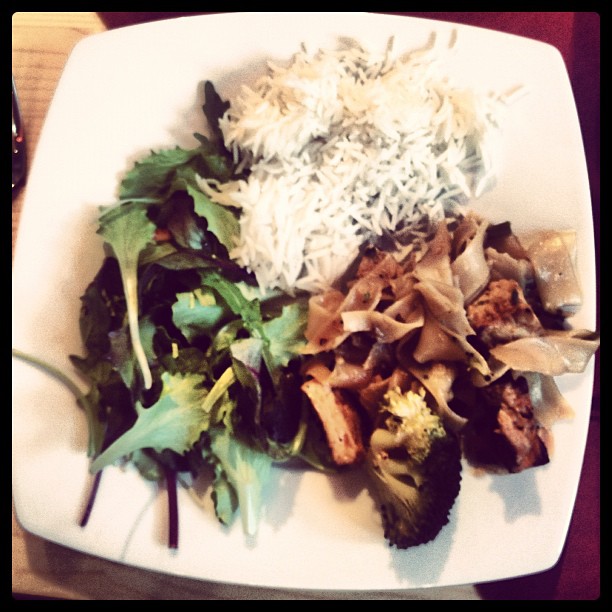 A plate with Broccoli, rice and some tofu