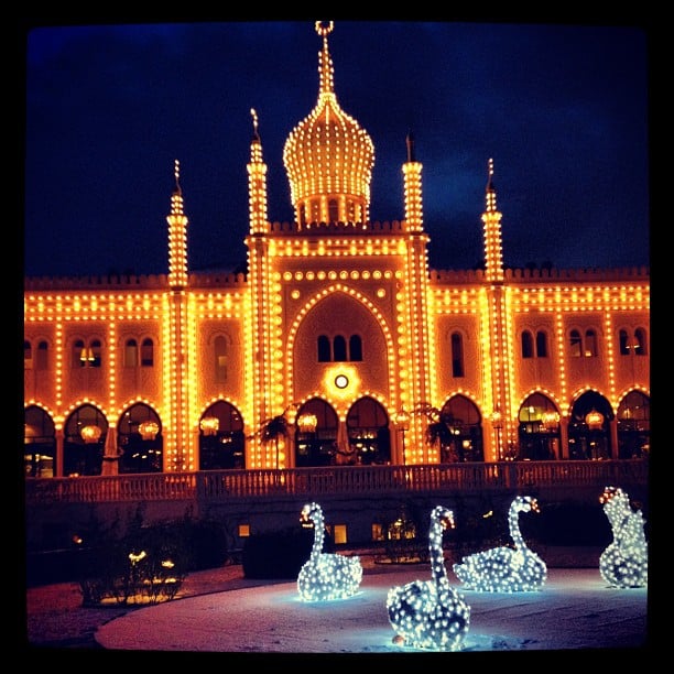 An oriental looking building covered in fairy lights.