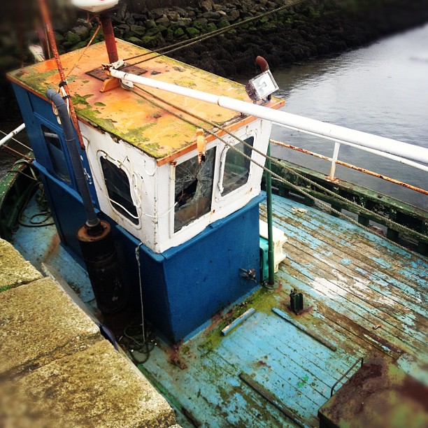 An old shabby boat with a Tiel deck