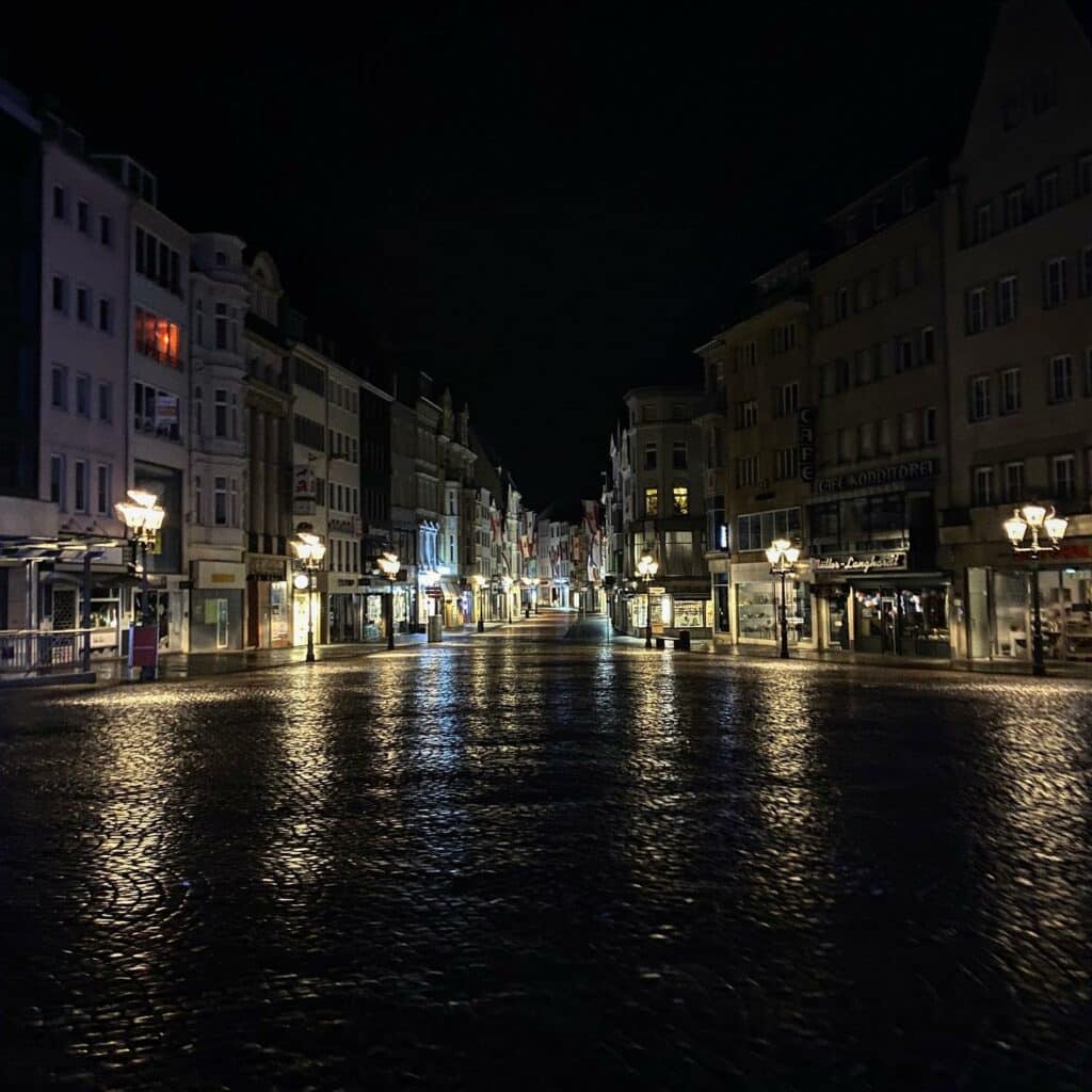 Empty pedestrian area at night, reflective stone floor