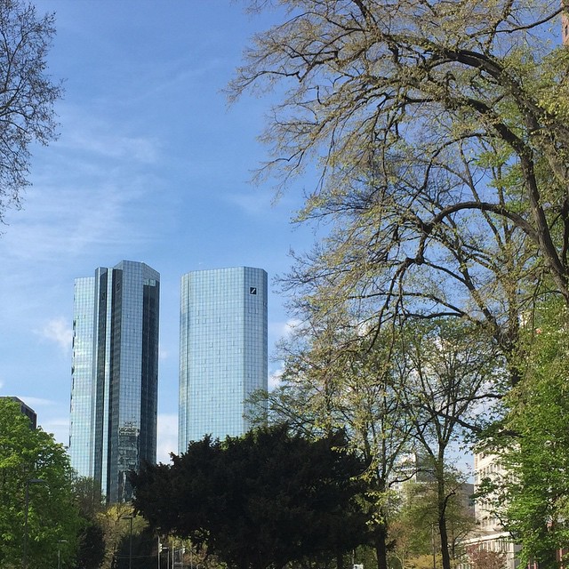 Two high-rises in the distance, a park in the foreground