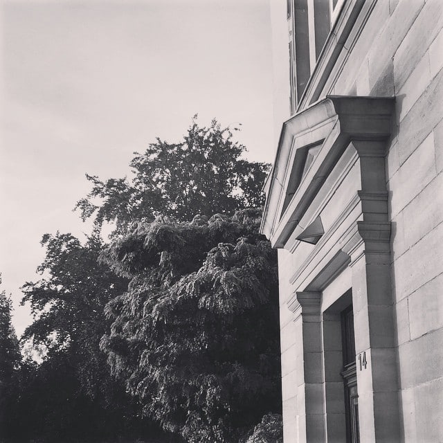 Black and white shot of a building facade and some trees