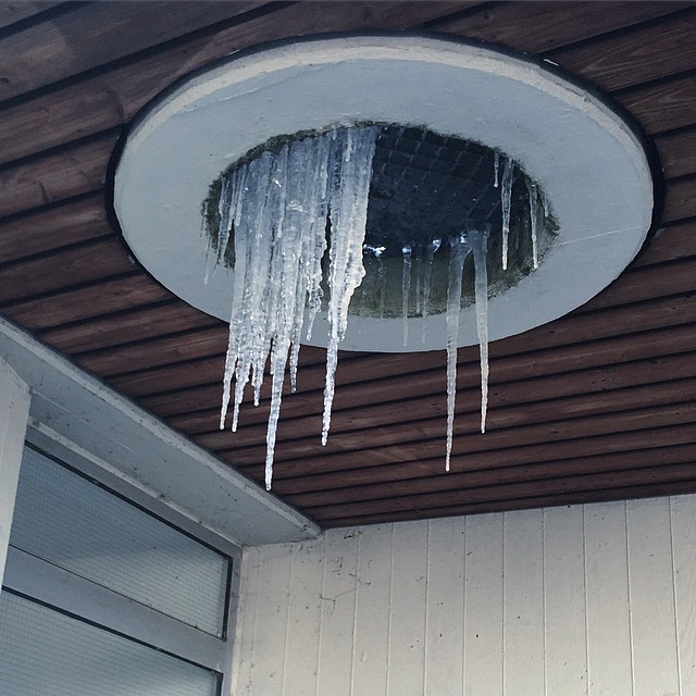 Popsicles hanging from a round structure on the ceiling