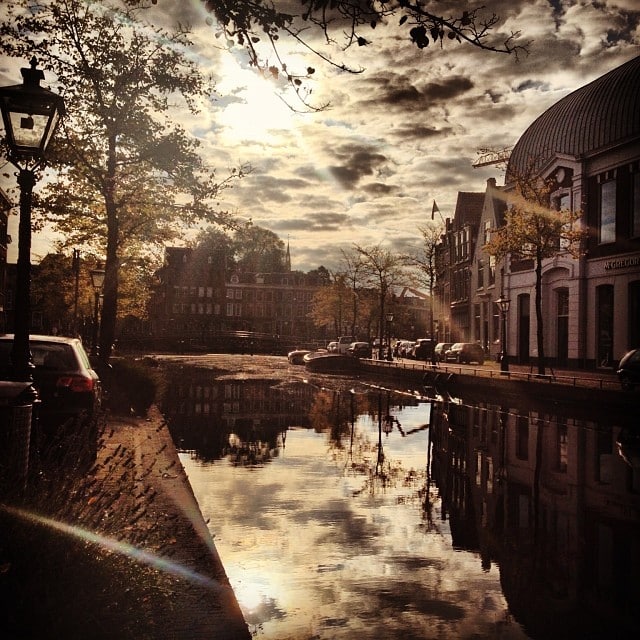 A body of water in a city in the fall sun