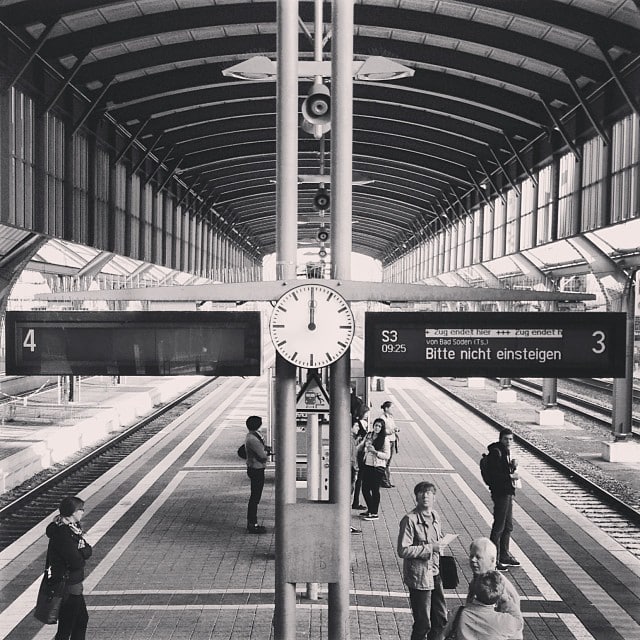 A train platform with a broken display and broken clock