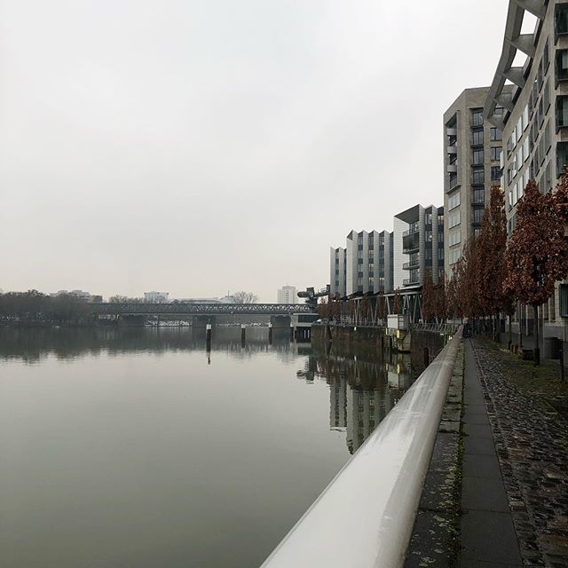 A slow wide river on the left, a couple of residential houses on the right