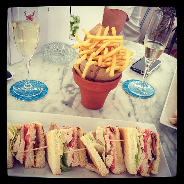 A plate with club sandwiches and some fries