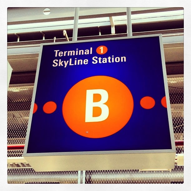 Sign in an airport reading "Terminal 1 SkyLine Station B"