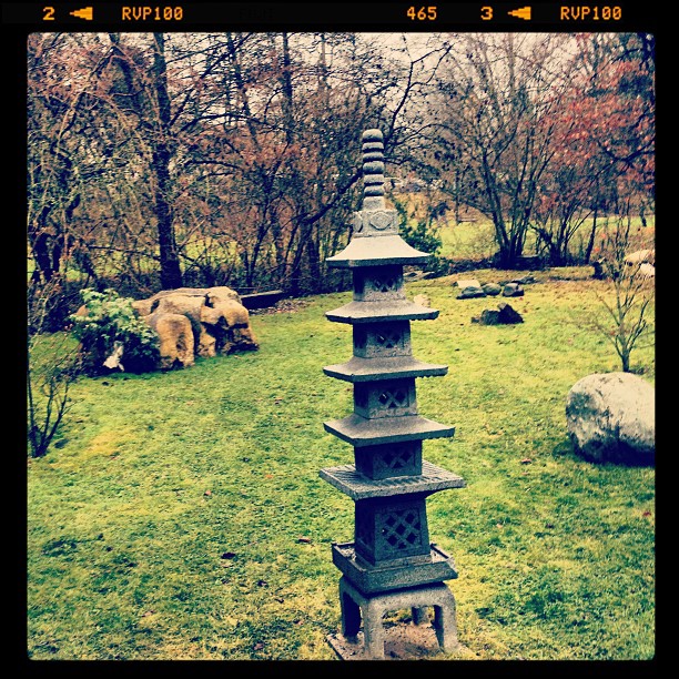 A small stone statue in a garden