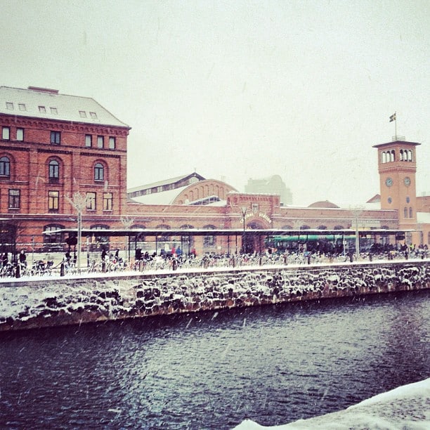 A red brick building behind a body of water