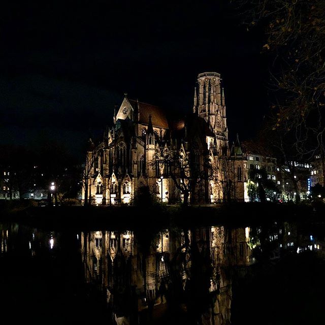 An old gothic cathedral next to a little lake