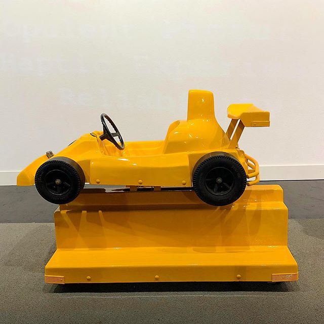 A bright yellow toy racecar