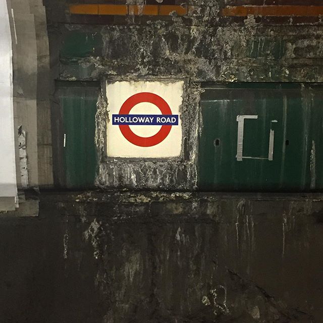 A London Underground sign reading "Holloway Road" surrounded by disgusting ooze