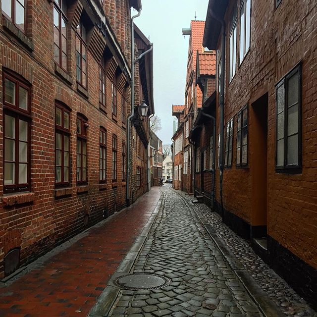 a narrow alleyway between old brick houses